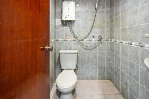 a bathroom with a toilet and a shower at RedDoorz near Istana Bogor in Bogor