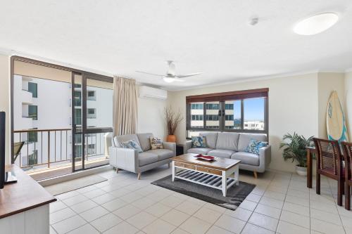 a living room filled with furniture and a large window at Langley Park Apartments in Maroochydore