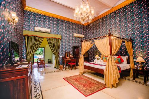 a bedroom with a large bed and a large window at The Grand Imperial - Heritage Hotel in Agra
