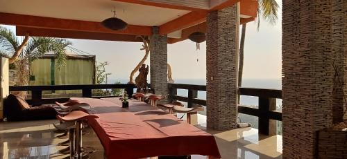 a patio with a table and a giraffe in the background at Rara Villas Lombok in Senggigi 