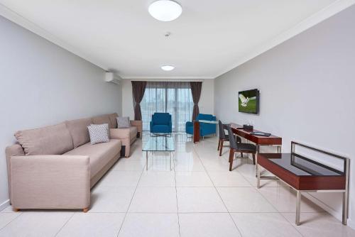 a living room with a couch and a table at Best Western Casula Motor Inn in Liverpool