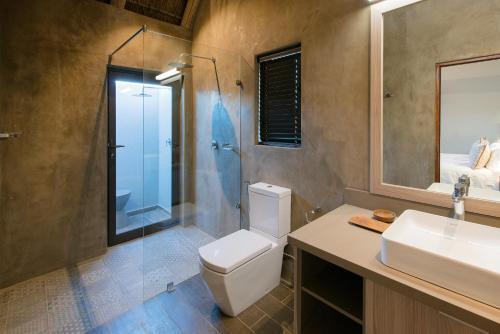 a bathroom with a toilet and a sink and a shower at Buckler's Africa Lodge Kruger Park in Komatipoort