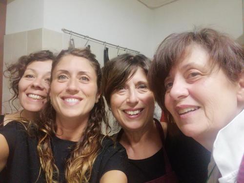 a group of four women posing for a picture at La Locanda Dell'olmo in Orvieto