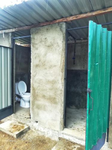 an open door to a bathroom with a toilet at Eco Lodge Haputale-Camping Sri lanka in Haputale