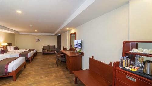 Postel nebo postele na pokoji v ubytování Hotel De La Renaissance