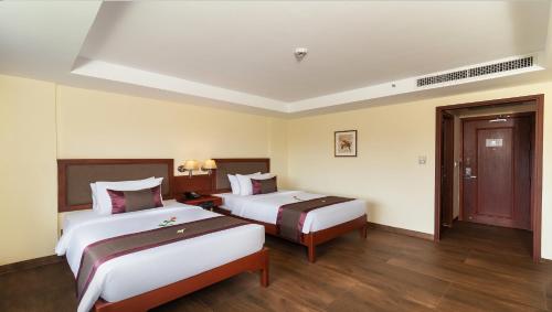Postel nebo postele na pokoji v ubytování Hotel De La Renaissance