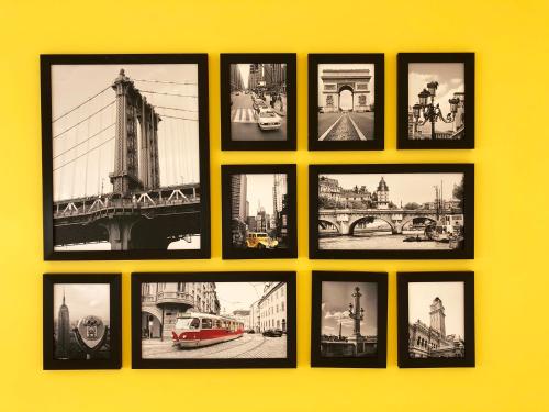a group of pictures on a yellow wall at La Krasse Angelroad in Tonosho