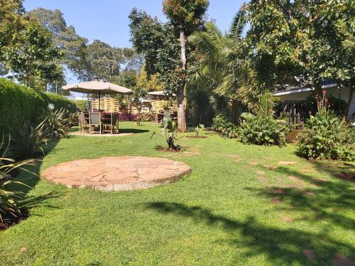 a garden with a stone circle in the grass at Sahara Gardens-Kericho in Kericho