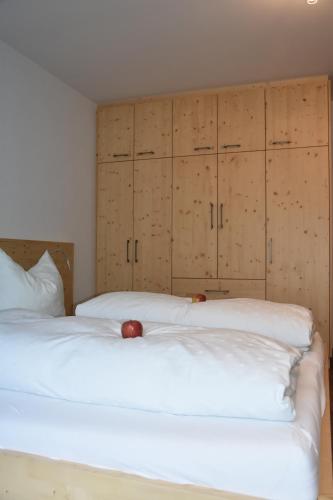 a bedroom with two beds and wooden cabinets at Haus Mortna in Liesing