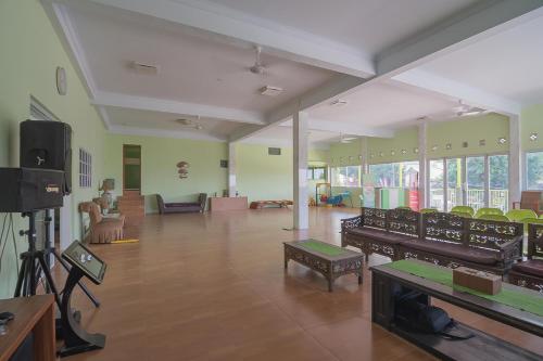 a large room with chairs and tables in a building at RedDoorz Syariah near Museum Wisma Karya Subang in Subang
