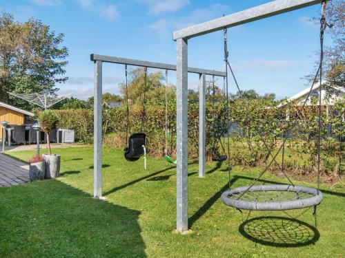 an empty swing set in a yard at 8 person holiday home in Hemmet in Hemmet