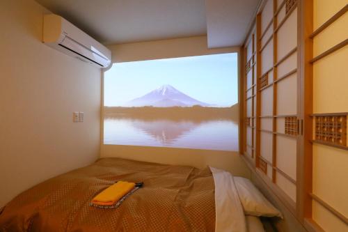 a room with a view of a mountain through a window at Tabist Wa Style Tokyo in Kawaguchi
