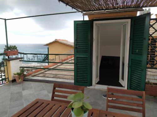 a room with a balcony with a view of the ocean at La mansarda sul Porto in Camogli