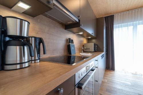 a kitchen with a counter top with a coffee maker at A Casa Elegance in Längenfeld