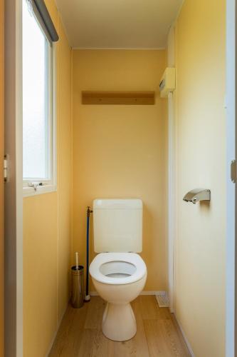 a bathroom with a white toilet in a room at Vakantiepark de Bergen in Wanroij