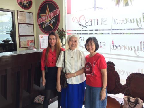 a woman and two girls standing next to an older woman at Hollywood Suites in General Santos