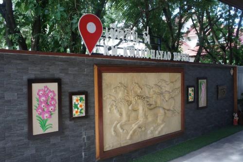 a wall with a painting of people and flowers at KM Kwanphayao Hotel in Phayao