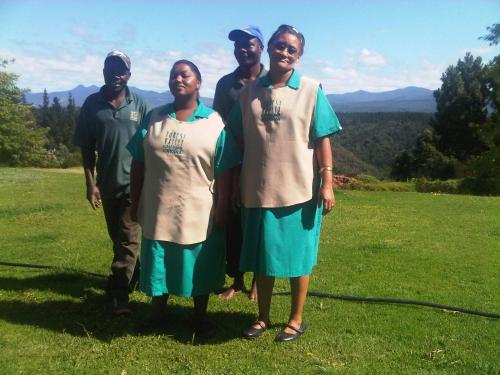 a group of people standing in a field at Forest Valley Cottages in Knysna