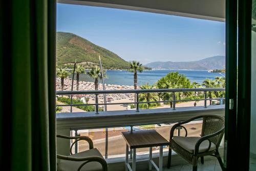 a view of a beach from a room with a window at Hotel Chateau de Ville in Marmaris