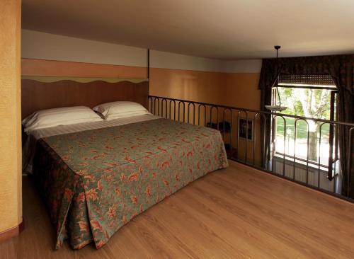 a bedroom with a bed and a balcony at Residence Liberty in Parma