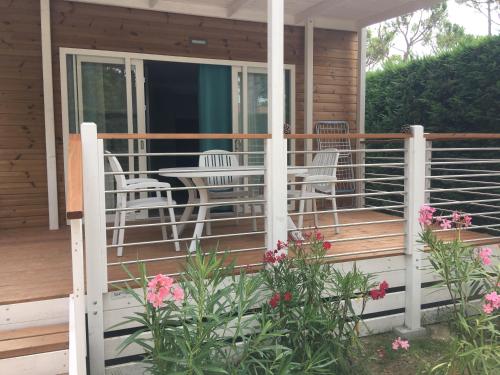 a porch of a house with chairs and a table at Dune Prestige & Chalets in Bibione