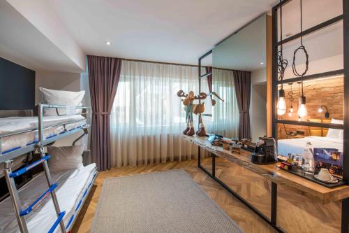 a bedroom with two bunk beds and a desk at Caro Hotel in Bucharest