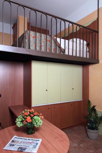 a bedroom with a bunk bed and a table with flowers at Residence Liberty in Parma