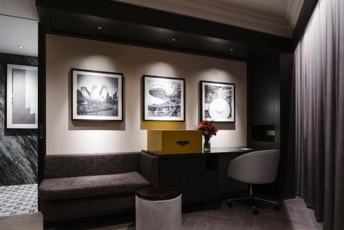 a office with a desk and a chair and pictures on the wall at Grand Park City Hall in Singapore