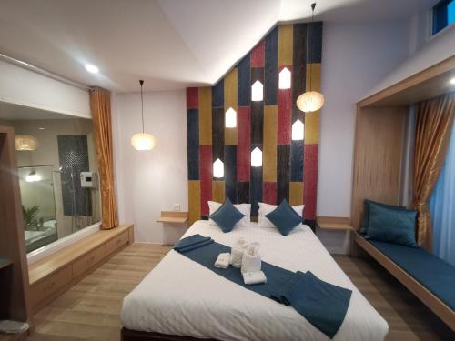 a bedroom with a bed with two teddy bears on it at เดอะชาลี The Charlie in Nan