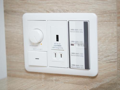 a white light switch sitting on top of a table at CABIN&HOTEL ReTIME in Naha