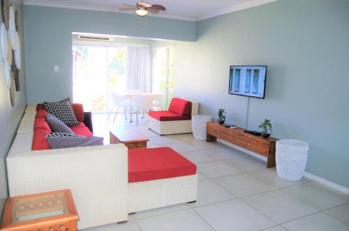a living room with two couches and a tv at 28 and 29 The Bridge in St Lucia