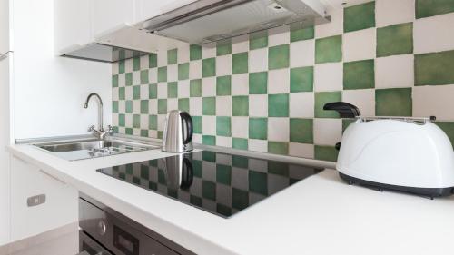 a kitchen with a sink and a toaster on a counter at Italianway - Ottoventi Apartments in Lampedusa