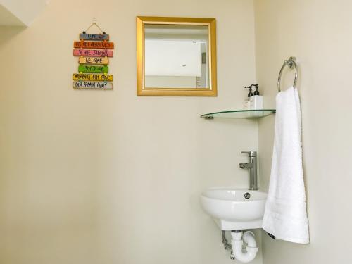 a bathroom with a white sink and a mirror at Mount Bay in Hout Bay