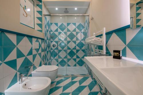 a bathroom with a sink and a toilet at Gea Suite B&B in Sorrento