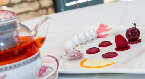 a white plate with different types of desserts on it at Frédéric Carrion - Cuisine, Hôtel & Spa in Viré