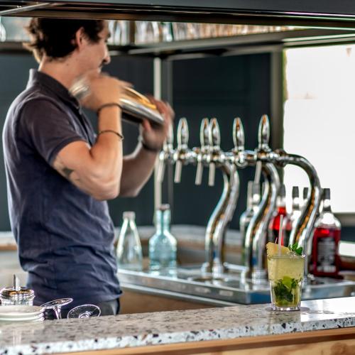a man is standing in a kitchen with a sink at Eklo Bordeaux Centre Bastide in Bordeaux