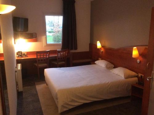 a hotel room with a bed and a desk at Armony Hotel in Bourg-Achard