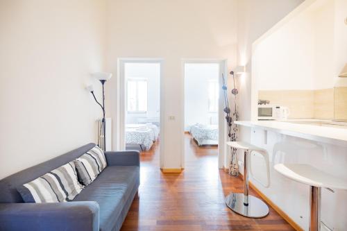 a living room with a couch and a kitchen at Stay In Rome in Rome