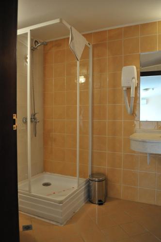 a shower with a glass door in a bathroom at Plaza Hotel in Varna City