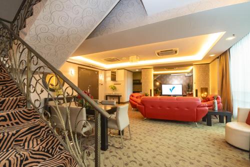 a living room filled with furniture and a red couch at Kinta Riverfront Hotel & Suites in Ipoh