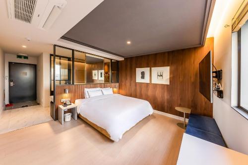 Ένα ή περισσότερα κρεβάτια σε δωμάτιο στο Brown-Dot Hotel Ulsan-Sincheon