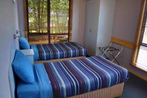 a hotel room with two beds and a window at Strahan Bungalows in Strahan