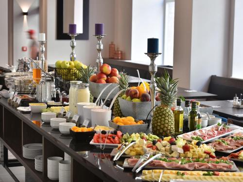 a buffet with many different types of food on a table at EA Hotel New Town in Prague