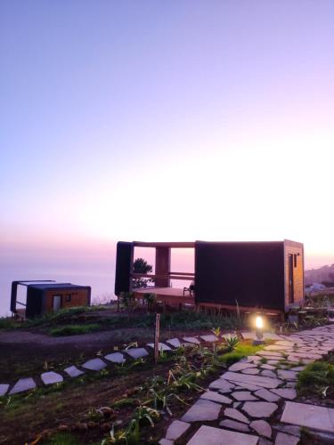 a house on top of a hill with a stone walkway at Calheta Glamping Pods - Nature Retreat in Calheta