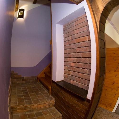 a room with a brick wall and stairs at Grisli house in Gauja
