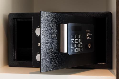 a microwave with its door open on a shelf at Postillion Hotel Amsterdam in Amsterdam