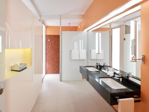 a bathroom with two sinks and a mirror at Radisson Blu Hotel & Convention Centre Kigali in Kigali