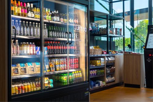 a refrigerator filled with lots of drinks in a store at Postillion Hotel Amsterdam in Amsterdam