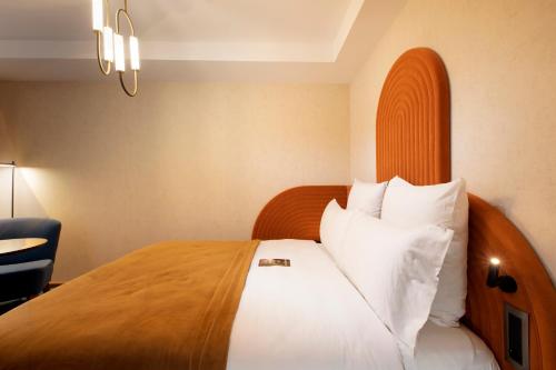 a bedroom with a large bed with white pillows at Mercure Istanbul Bakirkoy in Istanbul