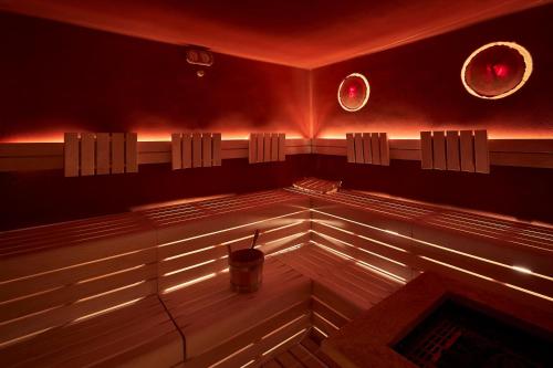 a sauna with a drink in the middle of the room at Hotel Al Sonnenhof in San Vigilio Di Marebbe